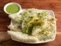 Khaman white Dhokla made up of rice or urad dal is a popular breakfast or Snacks recipe from Gujarat, India, served with Green Royalty Free Stock Photo