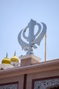 Khanda Sikh holy religious symbol at gurudwara entrance with bright blue sky image is taken at Sis Ganj Sahib Gurudwara in Chandni