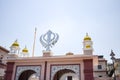 Khanda Sikh holy religious symbol at gurudwara entrance with bright blue sky image is taken at Sis Ganj Sahib Gurudwara in Chandni
