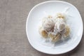 Khanom Tom Kao is Boiled sweets Thai traditional dessert in white plate. Royalty Free Stock Photo