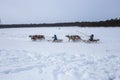 Khans men ride in the snow on a sleigh pulled