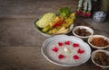 Khao-Chae, Cooked Rice Soaked in Iced Water in the white bowl and Eaten with the Usual Complementary Food and to decorate by