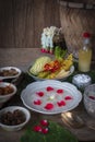 Khao-Chae, Cooked Rice Soaked in Iced Water in the white bowl and Eaten with the Usual Complementary Food and to decorate by Royalty Free Stock Photo