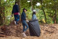 Khao Lak, Thailand, 1 june 2019: People of different nationalities cleaning garbage on the black beach to clean the