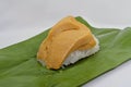 Khao niao sangkhaya or sticky rice with coconut custard with banana leaves, unwrapped, a delicious Thai dessert