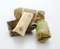 Khao Tom Mud, traditional Thai food Sticky rice wrapped in baitong and steamed until cooked on white background