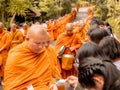 Khao Yai, Thailand - April 23, 2019: Buddhist Monks Line up in Row Waiting for Buddhism People to Give Alms Bowl in Makut Khiriwan