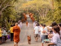 Khao Yai, Thailand - April 23, 2019: Buddhist Monks Line up in Row Waiting for Buddhism People to Give Alms Bowl in Makut Khiriwan