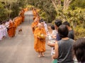 Khao Yai, Thailand - April 23, 2019: Buddhist Monks Line up in Row Waiting for Buddhism People to Give Alms Bowl in Makut Khiriwan