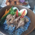 Khaow kha mooi thai cooking purple rice with pork boil egg chili