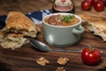 Kharcho soup with lamb meat served in a clay bowl with lavash flatbread