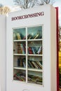 Open air bookcase with books behind glass. Bookcrossing in the park. Kharkiv city, Ukraine - March 30, 2024