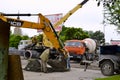 Two workers near excavator bucket