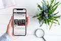 KHARKIV, UKRAINE - April 10, 2019: Apple iPhone X in female hand with washingtonexaminer.com site on the screen Royalty Free Stock Photo