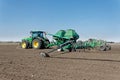 Tractor with trailed seeder on the field