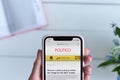 KHARKIV, UKRAINE - April 10, 2019: Woman holds Apple iPhone X with politico.com site on the screen