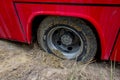 Kharkiv, Ukraine, August, 2019 Bus wheel is bogged down in sand. Red big car stuck in mud. Traffic problem on unpaved road. Dirty Royalty Free Stock Photo