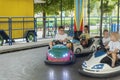 KHARKIV, UKRAINE- 18 AUGUST 2021: Children driving bumper car in an amusement park. Boys drive toy electric cars Royalty Free Stock Photo