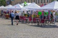 Kharkiv, Ukraine, August 2019 Open air cafe on city central square. Couple of man and woman walk by, talk and enjoy summer sunny Royalty Free Stock Photo