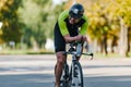 Triathlon biking man cycling on road bike at top speed on the triathlon race