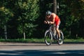 Triathlon biking man cycling on road bike at top speed on the triathlon race