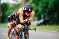 Triathon biking cyclist triathlete riding racing bike during ironman competition