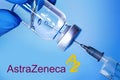 Kharkiv. Ukraine. February 1, 2021. Coronavirus vaccine vial with Astrazeneca logos on the background of a doctor in medical