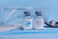 Kharkiv. Ukraine. February 1, 2021. Coronavirus vaccine vials with Pfizer logo and with AstraZeneca logo , syringe, mask, Royalty Free Stock Photo