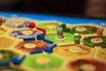 Kharkiv, Ukraine - Jan 05 2018: The Settlers of Catan, ongoing multiplayer board game. Settlements and robber focused Royalty Free Stock Photo