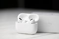 KHARKIV, UKRAINE - JANUARY 27, 2021: Apple AirPods Pro on a white background. Wireless headphones with charging case and a box. Royalty Free Stock Photo