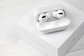 KHARKIV, UKRAINE - JANUARY 27, 2021: Apple AirPods Pro on a white background. Wireless headphones with charging case and a box. Royalty Free Stock Photo