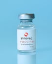 Kharkiv. Ukraine. January 9, 2021. Coronavirus vaccine vial with Sinovac logo a blue background.The concept of medicine,