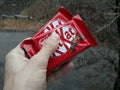 KHARKIV, UKRAINE - JANUARY 2, 2021 Kit Kat by Nestle chocolate covered wafer on bright color