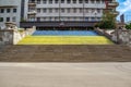 Big granite staircase up on Serhiivskyi Maidan in Kharkov. Old shabby steps painted yellow and