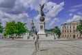 A male tourist wearing a medical protective face mask poses on Constitution Square in Kharkiv.