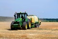 Kharkiv / Ukraine - June 27, 2019: Agricultural field of ripe sowing of rye, the harvester collects a rich crop of cereals