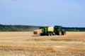 Kharkiv / Ukraine - June 27, 2019: Agricultural field of ripe sowing of rye, the harvester collects a rich crop of cereals