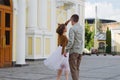 Kharkiv, Ukraine. 09.19.2021. Love story of stylish funny couple: young man in a t-shirt. And a cute young woman in white skirt