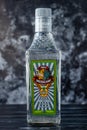 Kharkiv, Ukraine, November 14, 2019: A glass bottle of mexican tequila on dark background. Strong drink. Illustrative editorial.