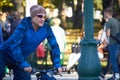 Elderly man rides a bicycle in a city park, selective focus Royalty Free Stock Photo