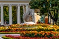 Flat sculpture of a squirrel in the middle of an autumn flower bed