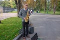 Kharkiv, Ukraine, September, 2019 Man plays on saxophone in the park. Street musician with sax performs music for charity. Public Royalty Free Stock Photo