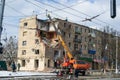 Kharkiv, Ukraine - 05.06.2022: Terrible destroyed building in city street crane dismantling damage house destruction