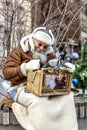 An old man playing a mechanical organ in a modern city Royalty Free Stock Photo