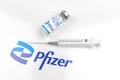 Kharkov, Ukraine - April 18, 2021: Coronavirus prevention and vaccination by using Pfizer vaccince vial and syringe