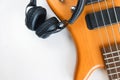 Marshall bluetooth headphones, wireless, and bass guitar on white background.