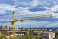 Kharkov, Ukraine - 24 April 2020: Yellow construction building crane on the construction site of a large residential modern high-