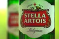 Bottles of Stella Artois beer on blurred green trees background Royalty Free Stock Photo