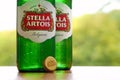 Bottles of Stella Artois beer on blurred green trees background Royalty Free Stock Photo