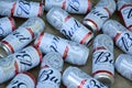 Many Cans of Budweiser Lager Alcohol Beer lies on camo surface. Budweiser is Brand from Anheuser-Busch Inbev most popular in